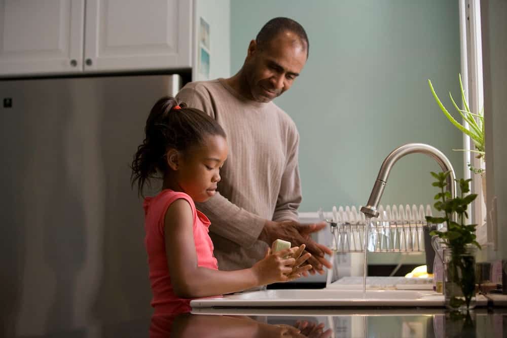 a father and daughter in the kitchen.