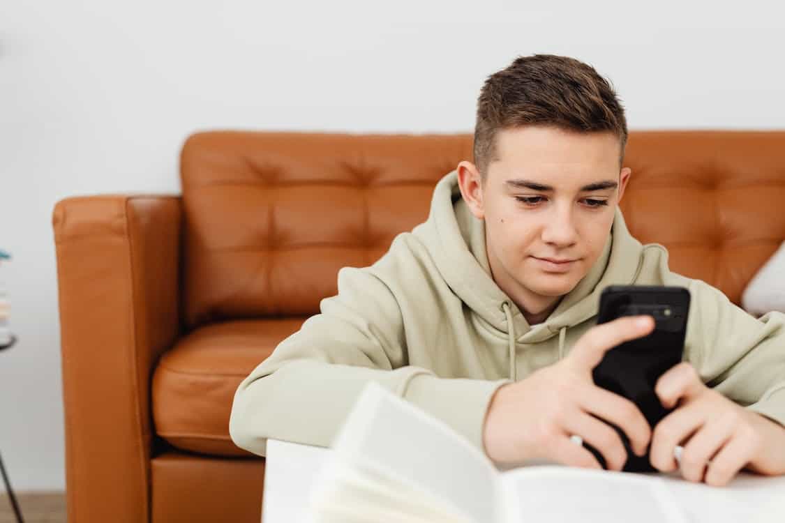 A teenager texting on his phone