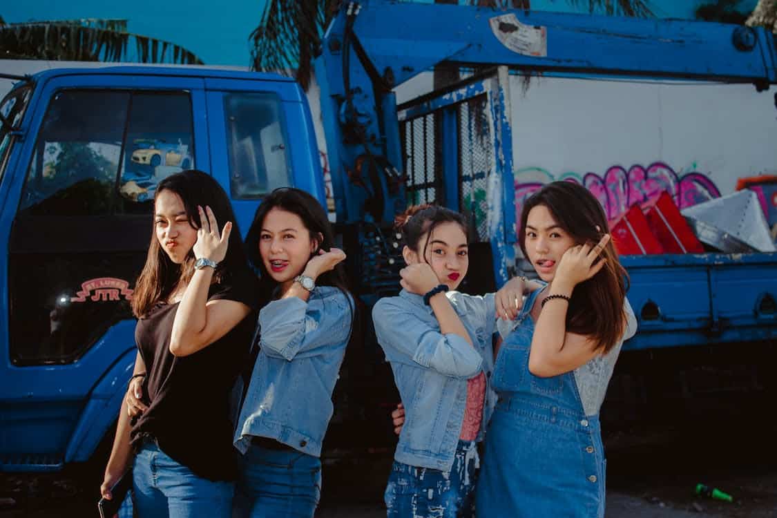 Teenagers standing in front of a truck